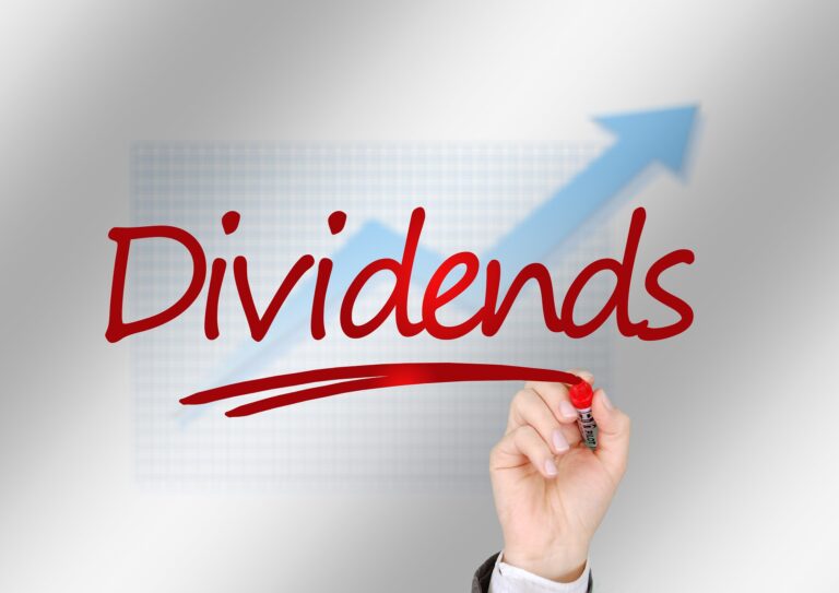 the word dividends with a stock chart moving upwards behind it